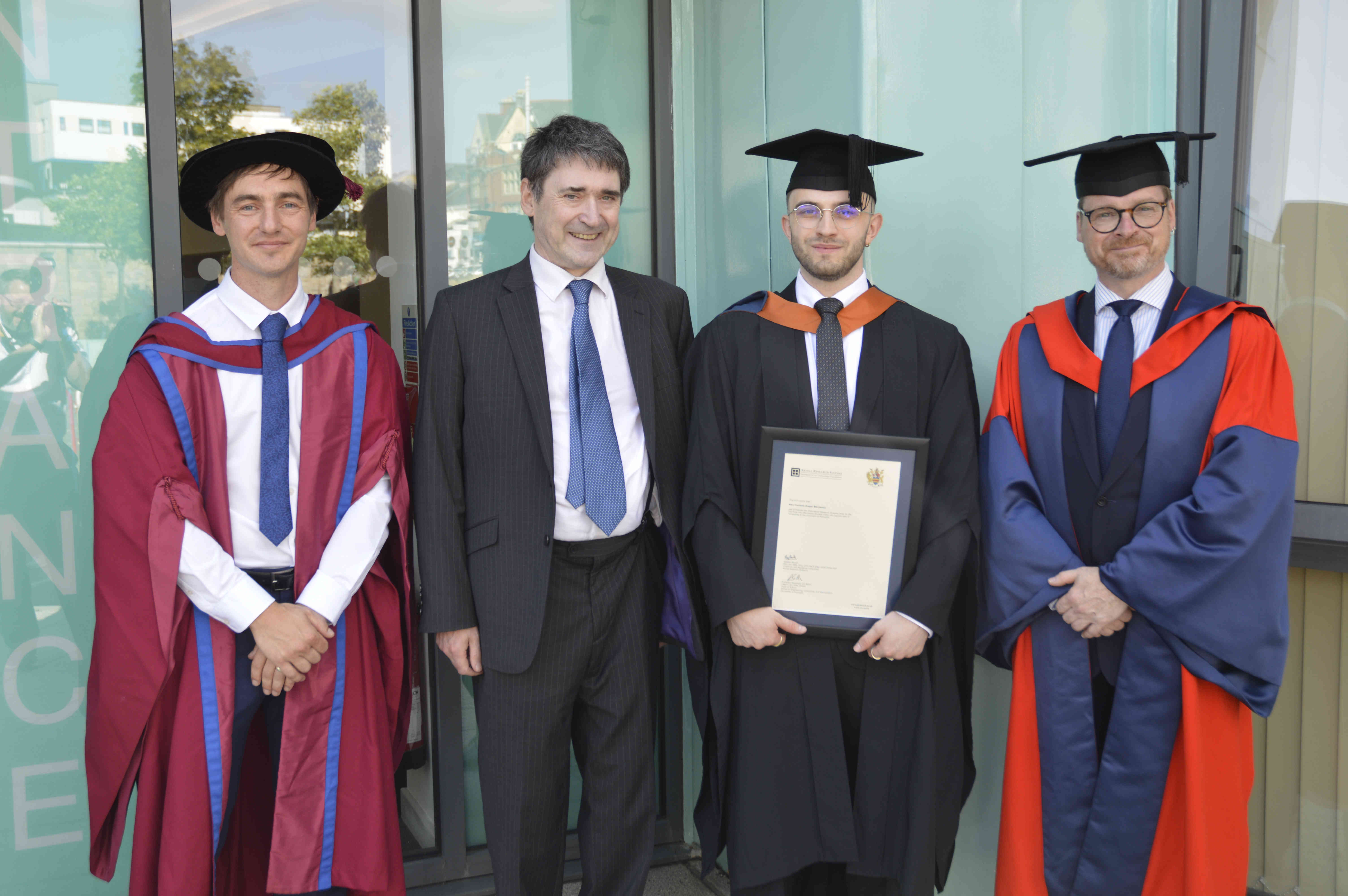 Alex Trzcinski-Draper with Dr Rory Hopcroft  (left), Alastair (second left) and Professor Alexander Belton (far right).